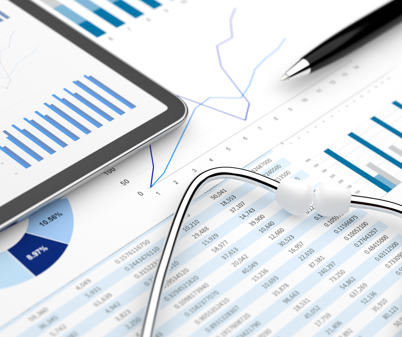 stethoscope on a white paper with charts and graphs, and a black pen