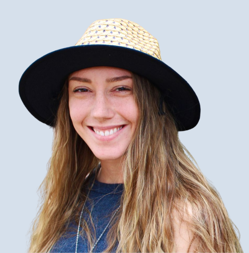 A woman wearing a black hat is smiling for the camera