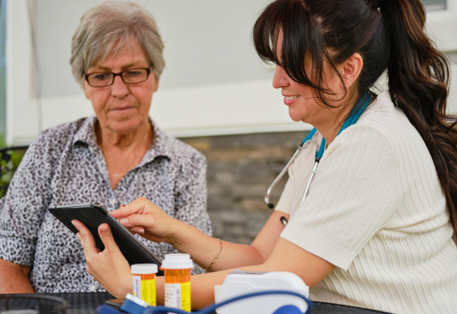 A medical provider is showing a patient something on an ipad