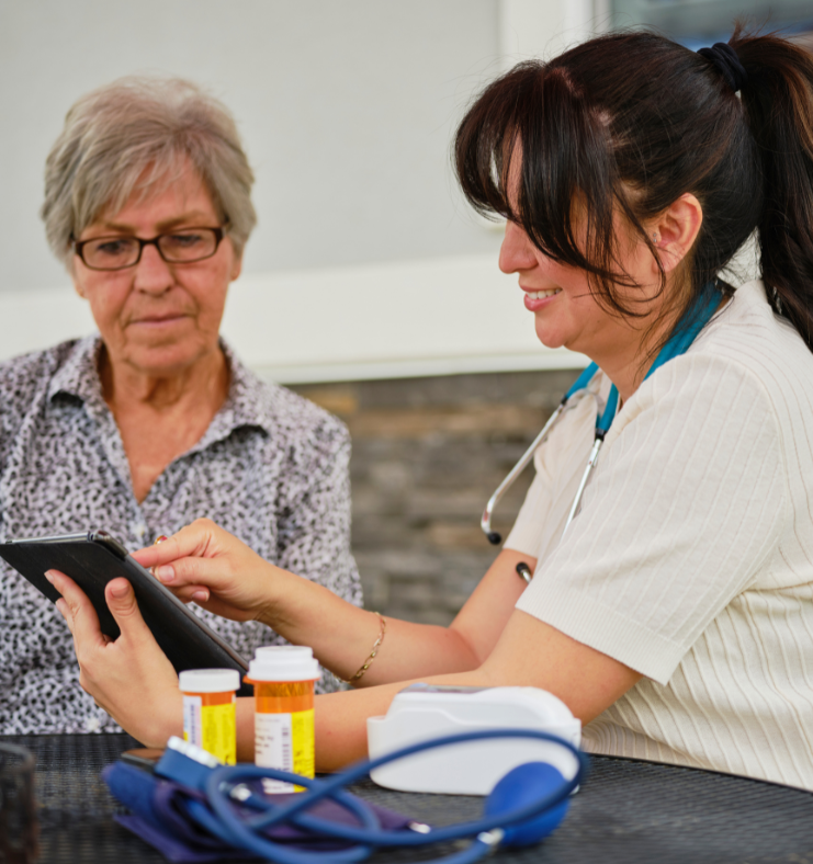 A medical provider is showing a patient something on an ipad