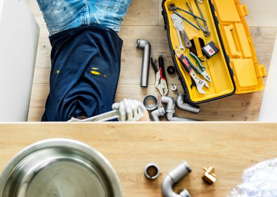 plumber fixing sink after a botched job