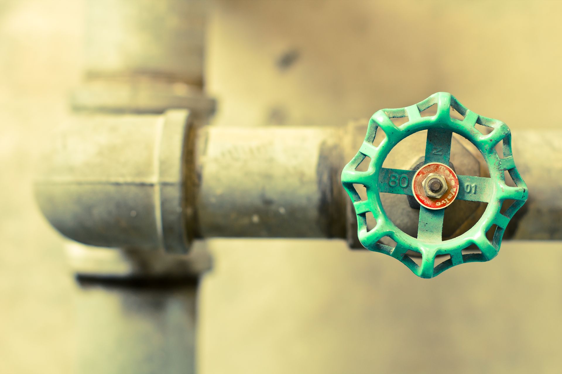 Green valve on gray pipes, likely for water control.