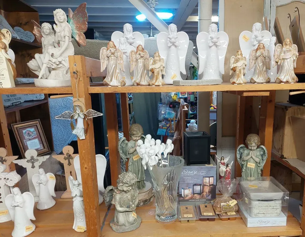 Shelves displaying various angel figurines and religious items.