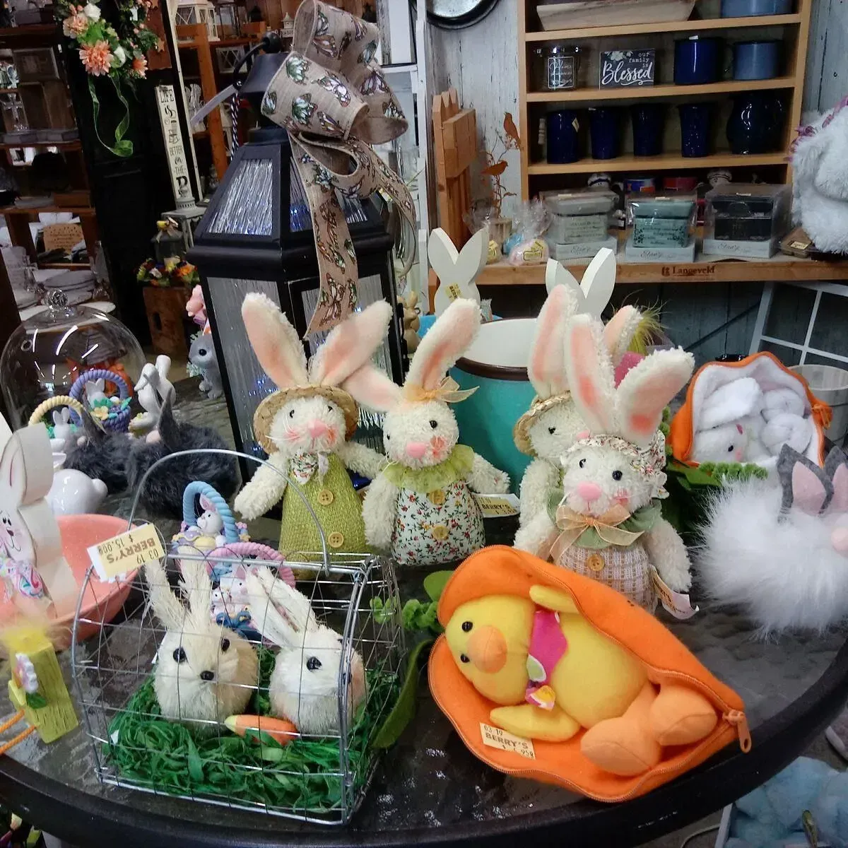 Easter display with bunny and chick toys on a table in a shop, featuring spring colors.
