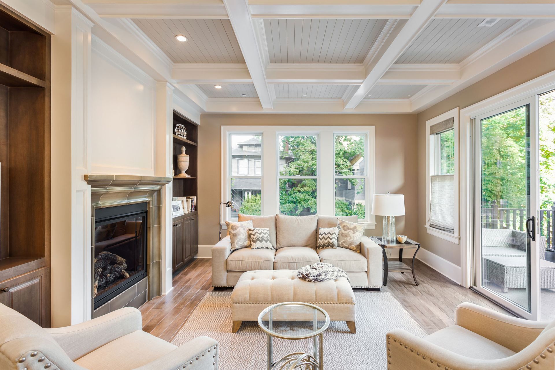 Living room with neutral tones, fireplace, built-in shelving, and large windows. Living room with neutral tones, fireplace, built-in shelving, and large windows.