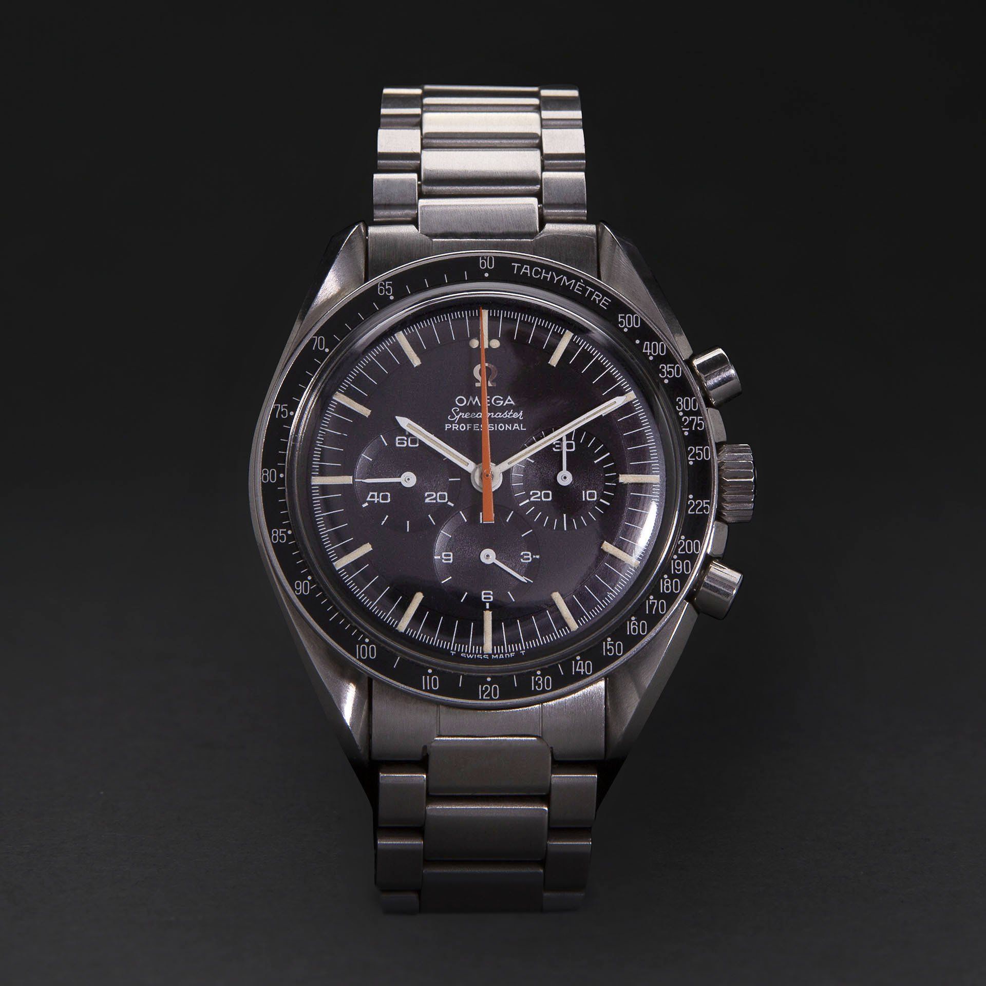 A silver watch with a black face and a silver band
