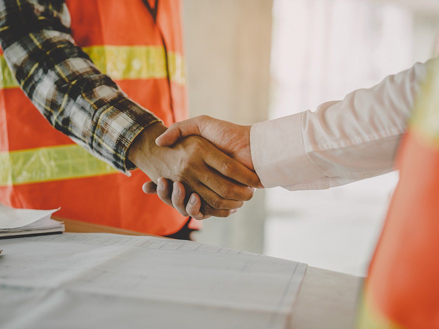 two construction workers handshaking