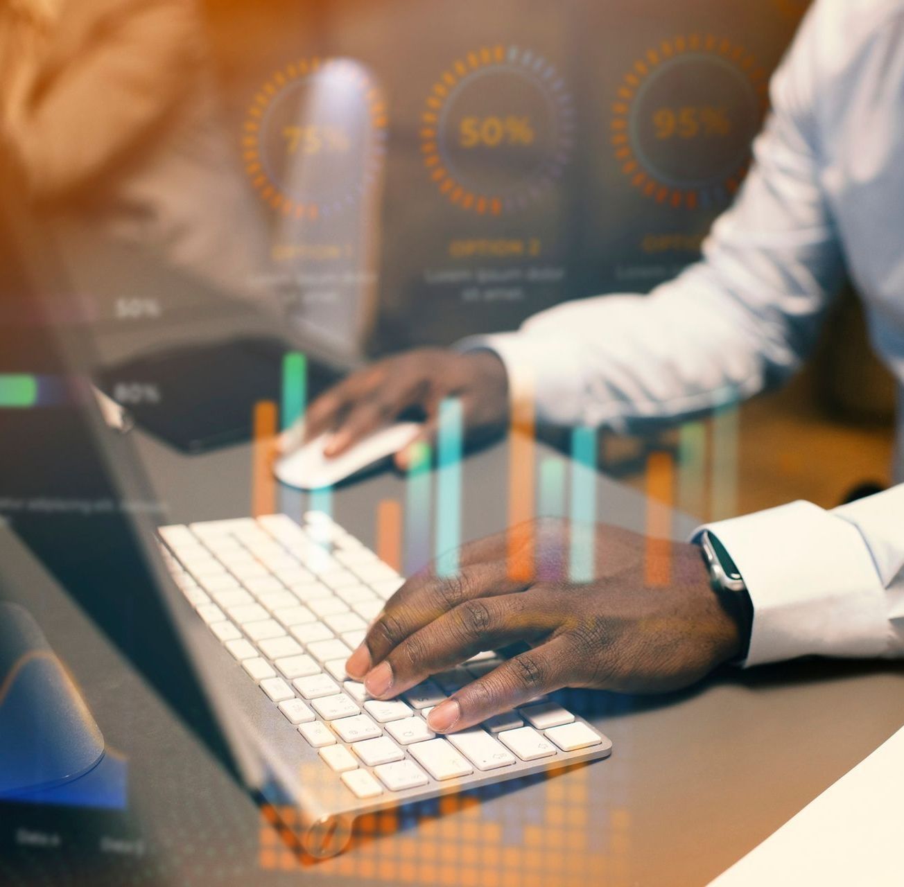 Man working on a computer with data visualizations overlaid. Hands on keyboard and mouse.
