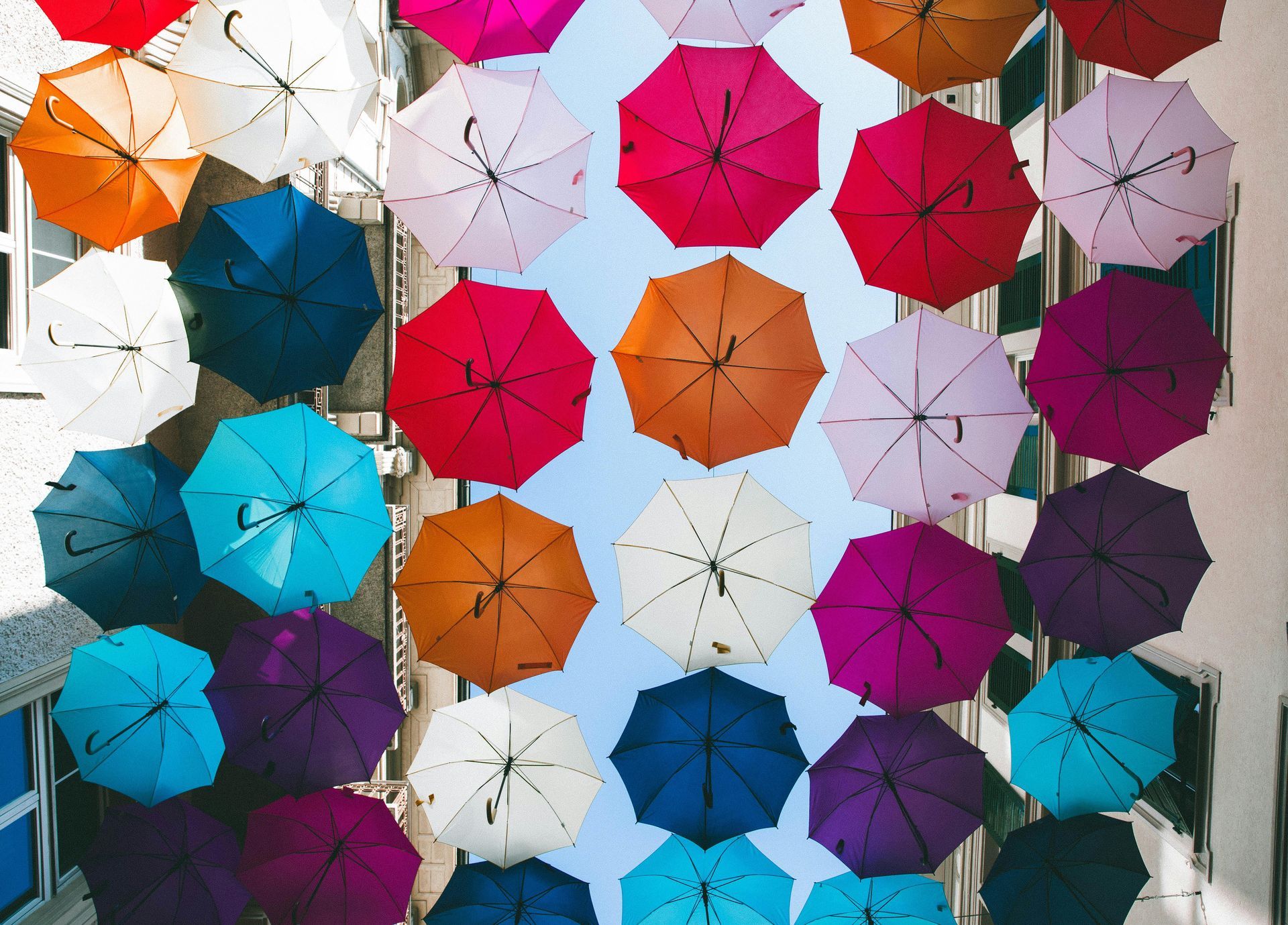 Colorful umbrellas hanging overhead in a decorative outdoor display
