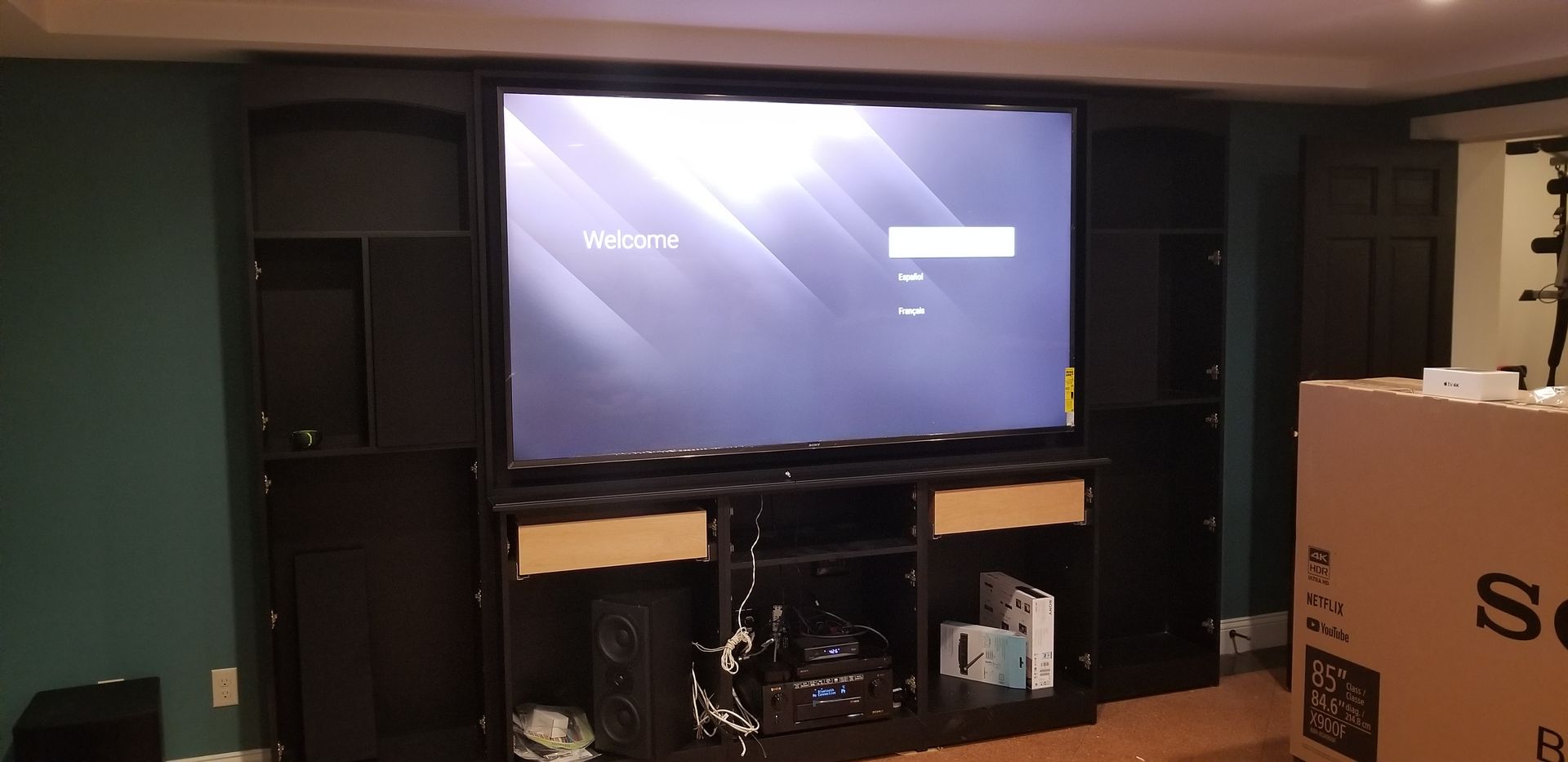A sony television is sitting on top of a wooden entertainment center.
