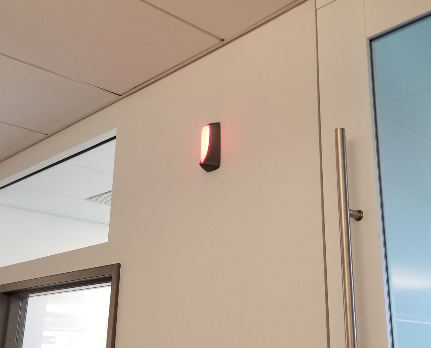 A light is hanging on a wall next to a door