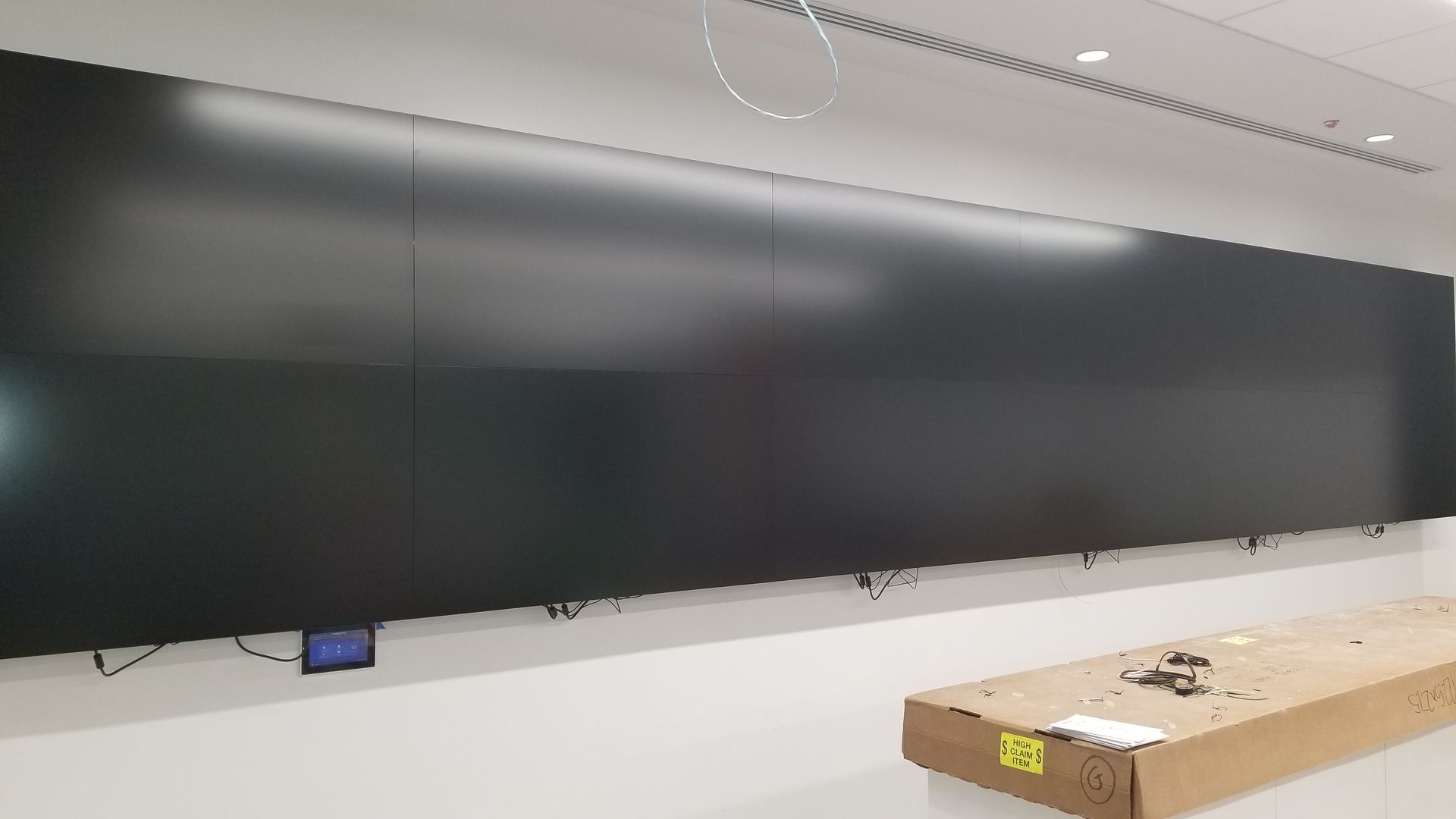 A large flat screen tv is hanging on the wall in a room.