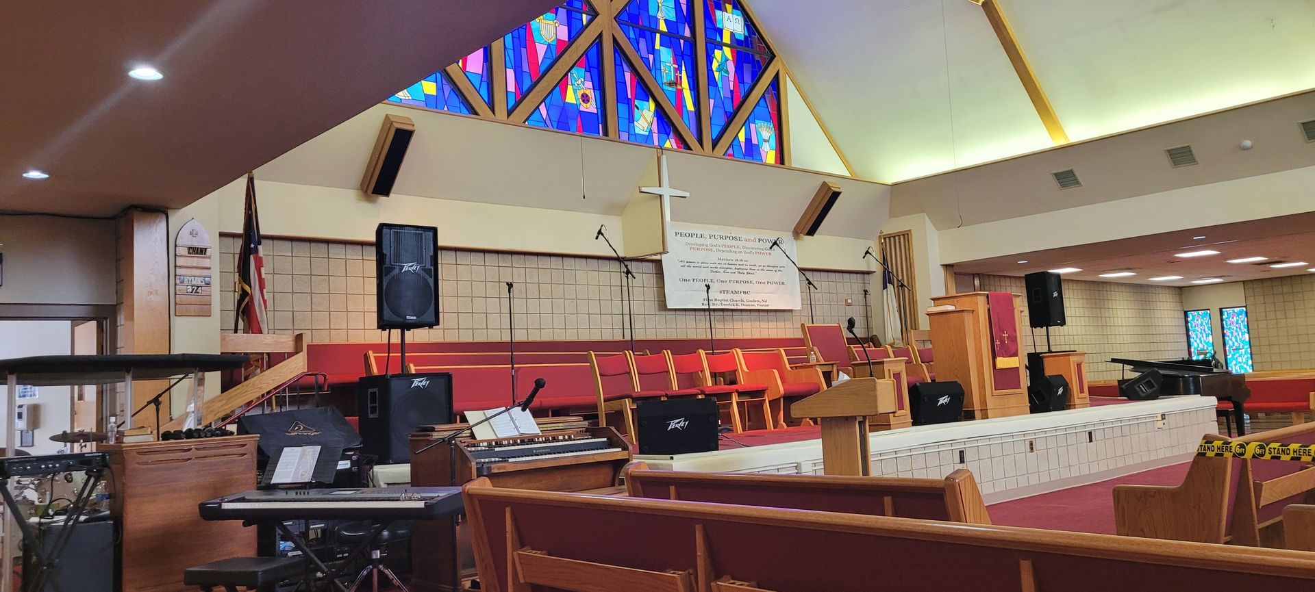 The inside of a church with a stained glass window.