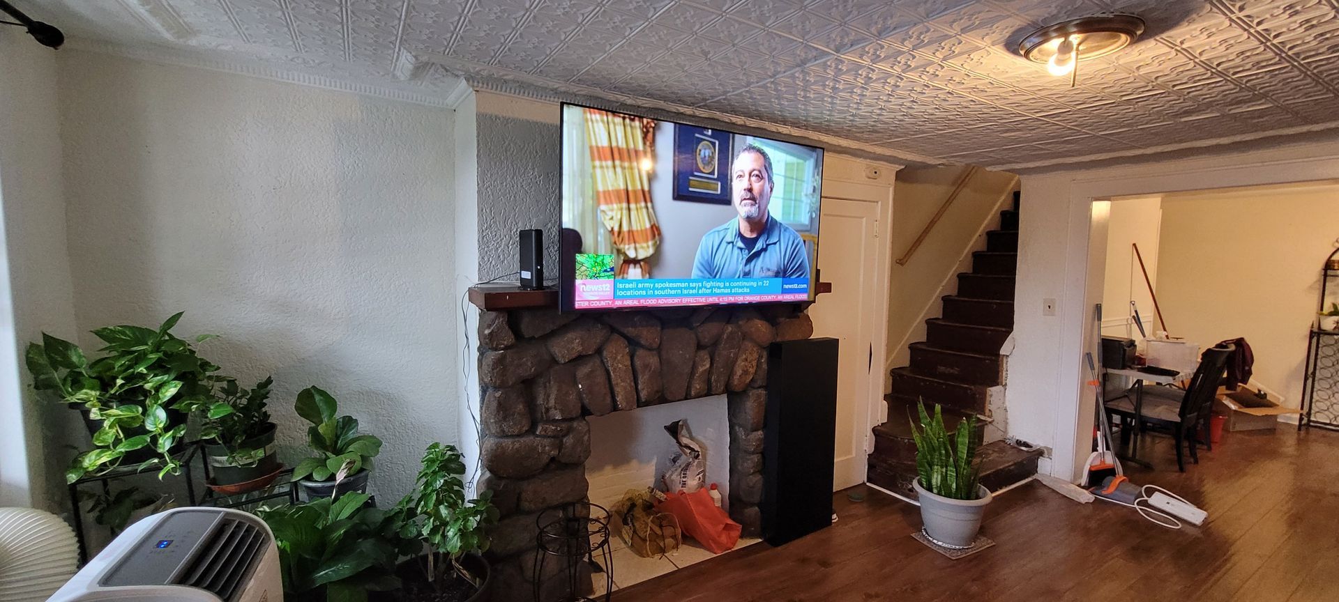 A living room with a fireplace and a flat screen tv.