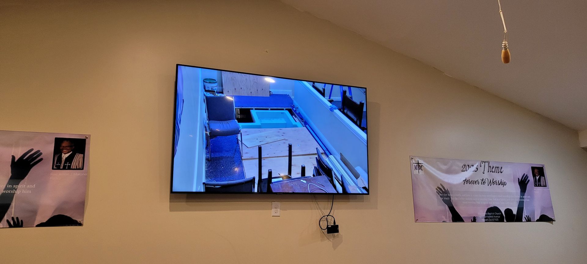 A large flat screen tv is hanging on a wall.