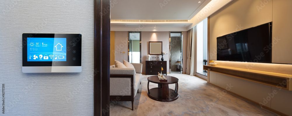 A living room with a thermostat and a television.
