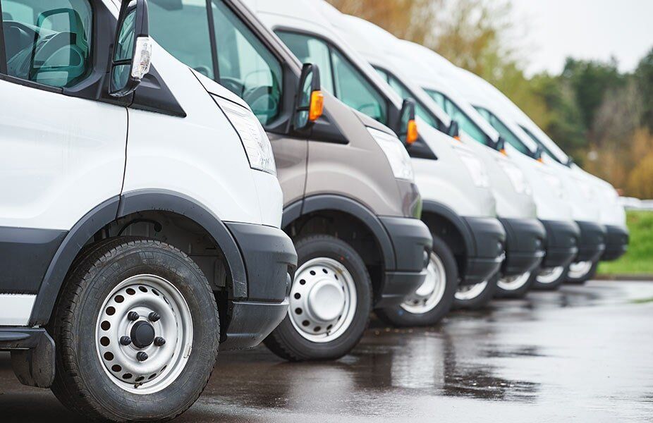 Fleet vehicles lined up on a wet road