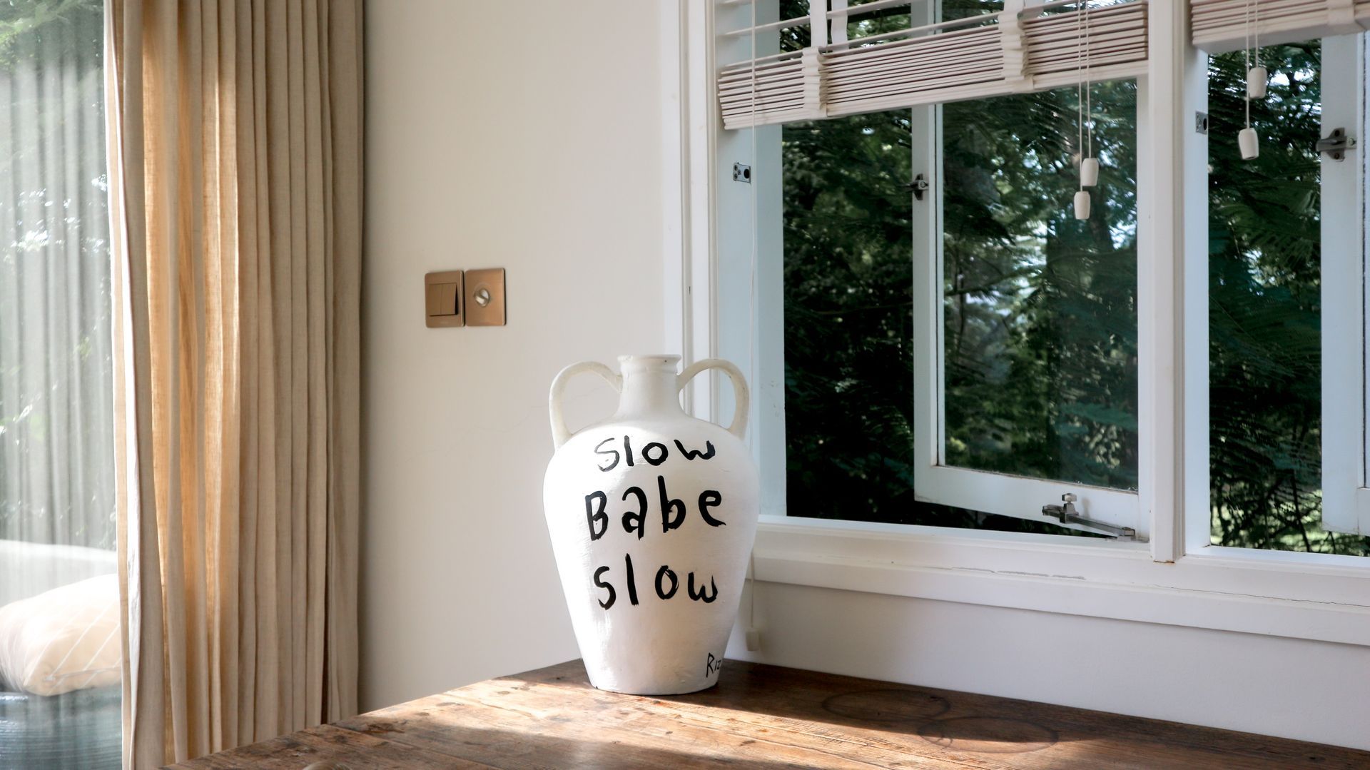 White vase with black text 