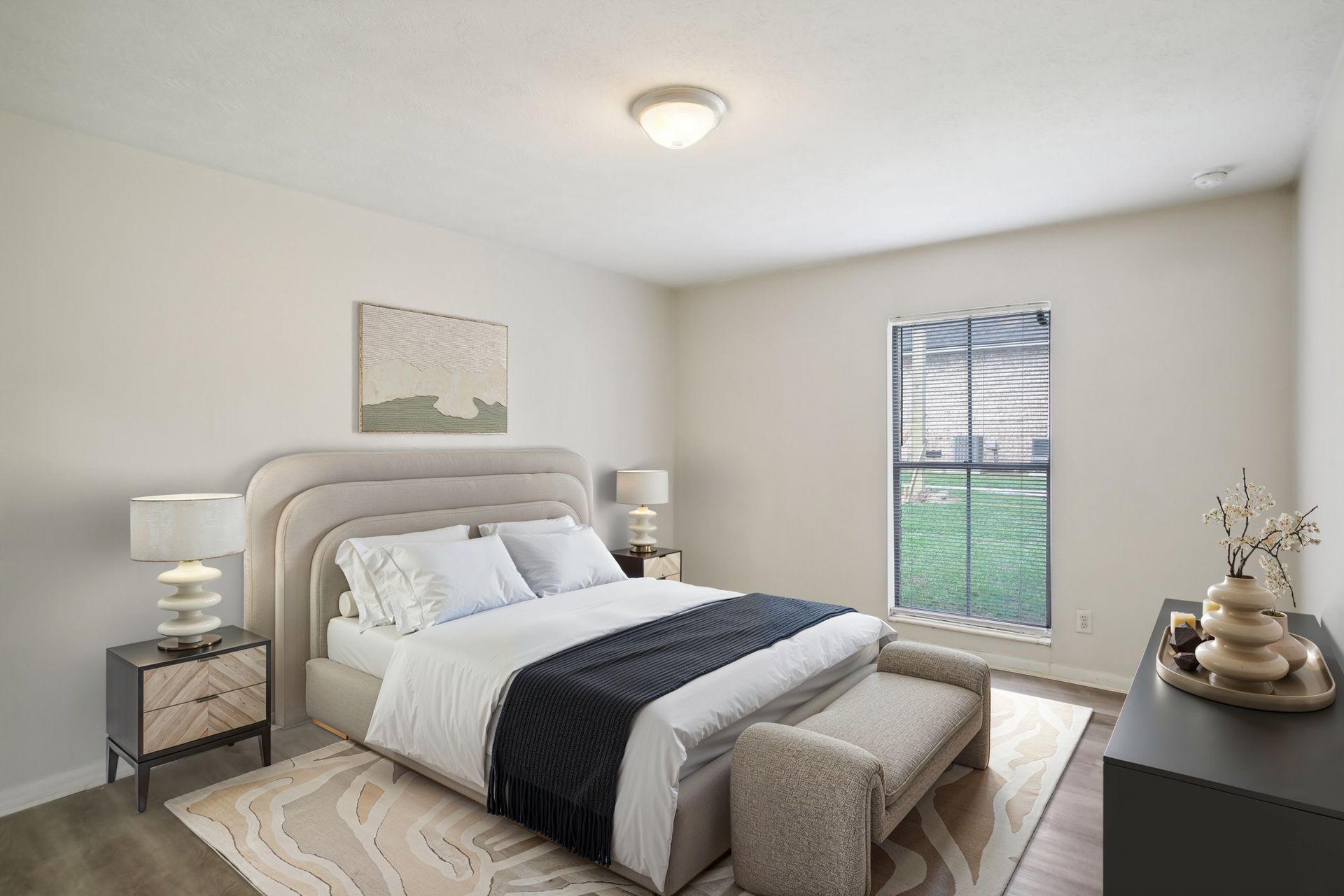 Bedroom with bed, nightstands, window, and decorative items. Soft colors, neutral palette.