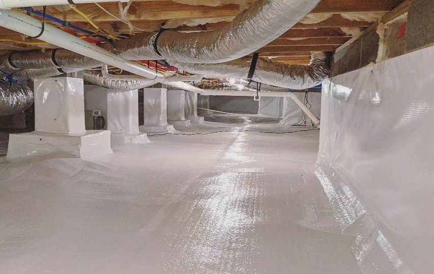 A newly encapsulated basement with a lot of pipes and ducts.