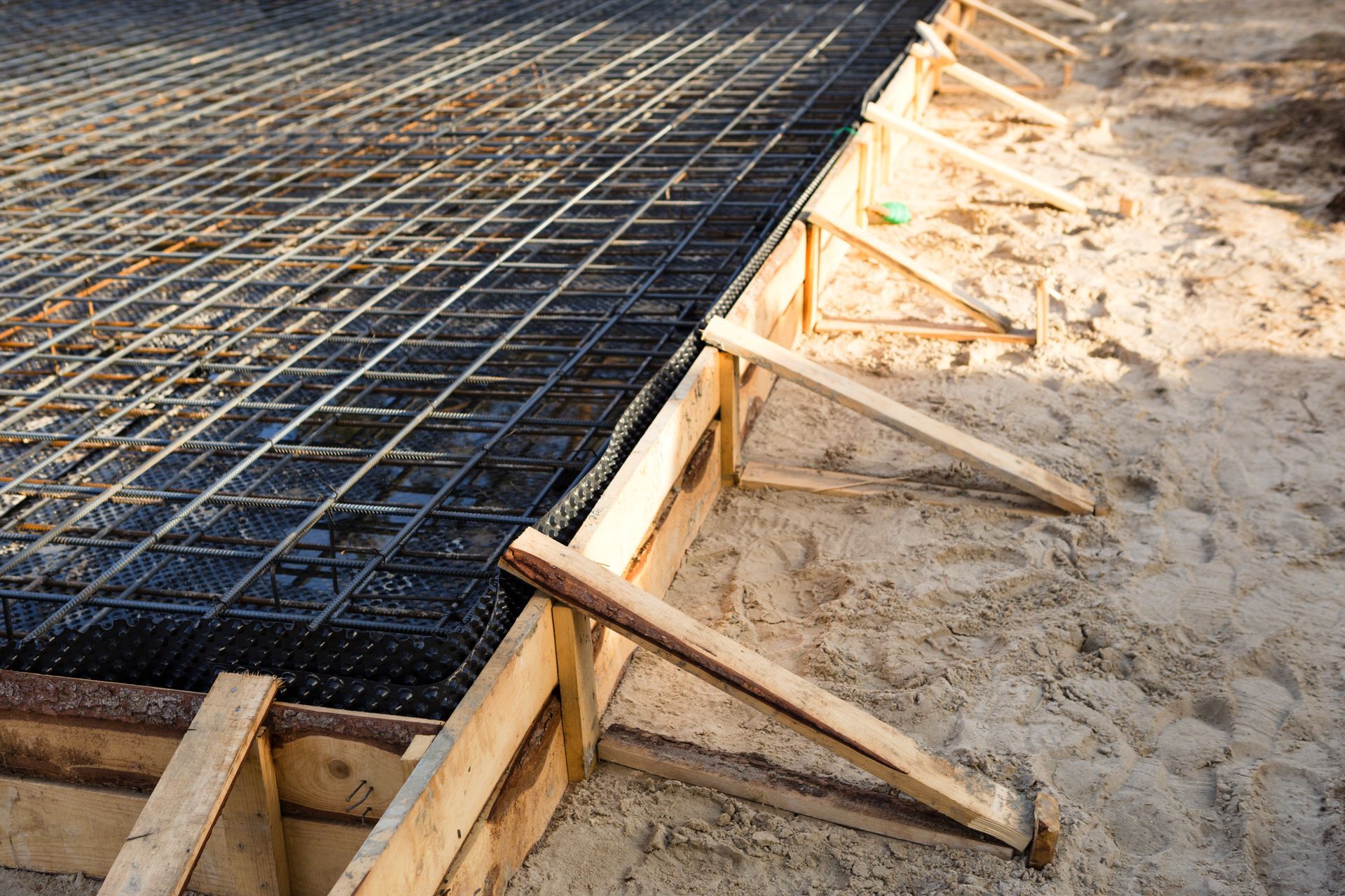 A concrete foundation is being built on a construction site.