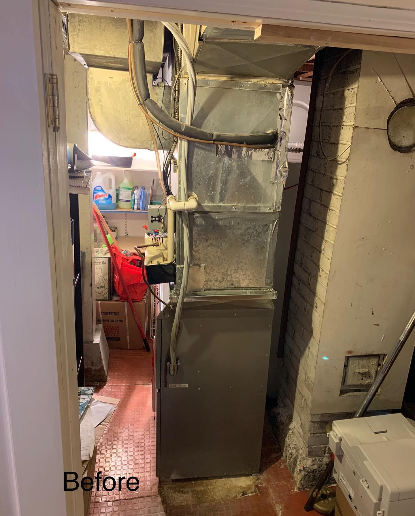 A room with a refrigerator and a stove in it.