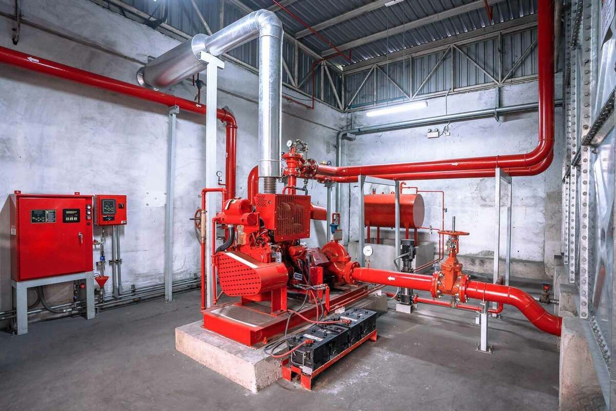 A room filled with lots of red pipes and pumps.