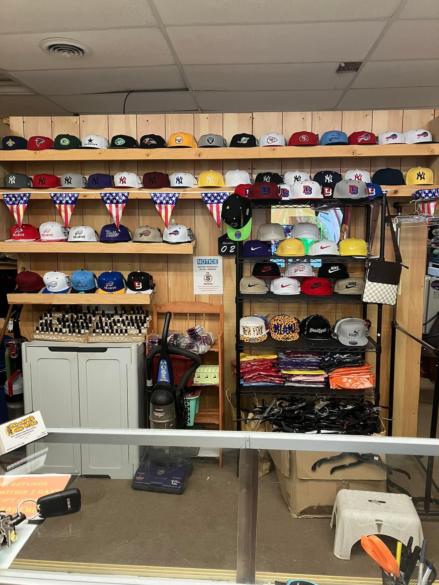 A retail display with rows of baseball caps on wooden shelves and a metal rack, featuring a mix of colors and designs.