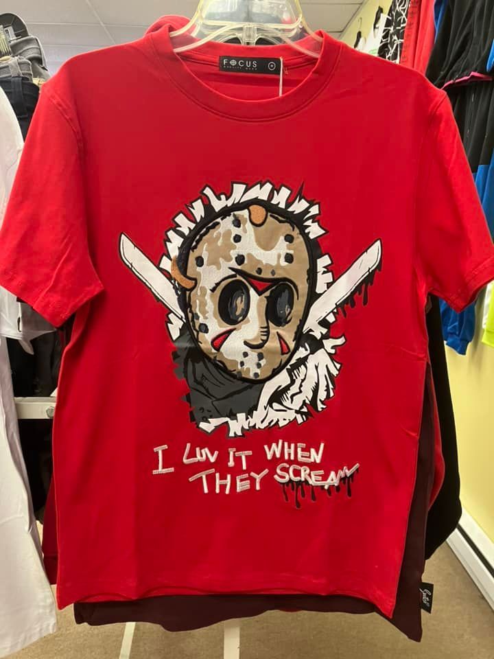A bright red graphic t-shirt featuring a cartoon Jason Voorhees mask, two blades, and the text 