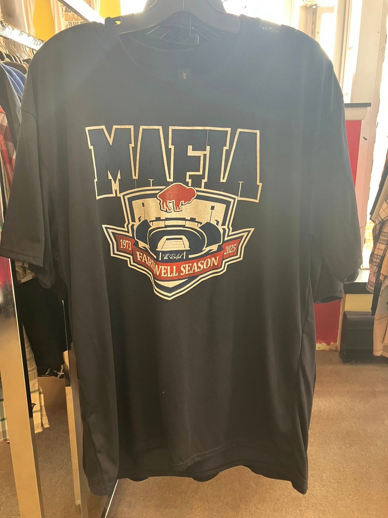A black t-shirt hanging on a rack featuring a "Buffalo Mafia" graphic logo in blue, red, and white.
