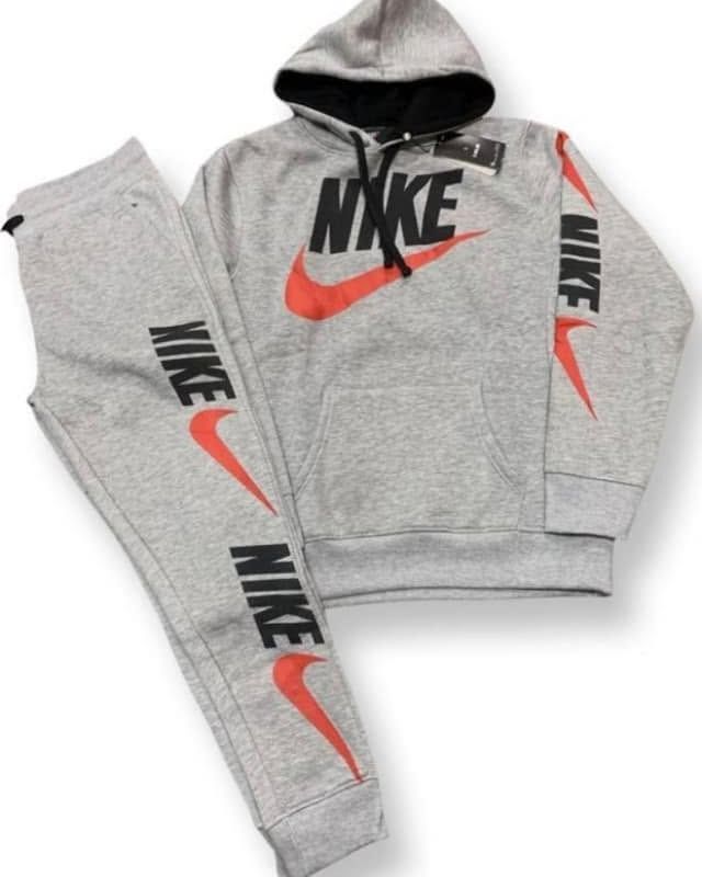 A grey Nike hoodie and matching sweatpants set, featuring black text and orange swoosh logos.