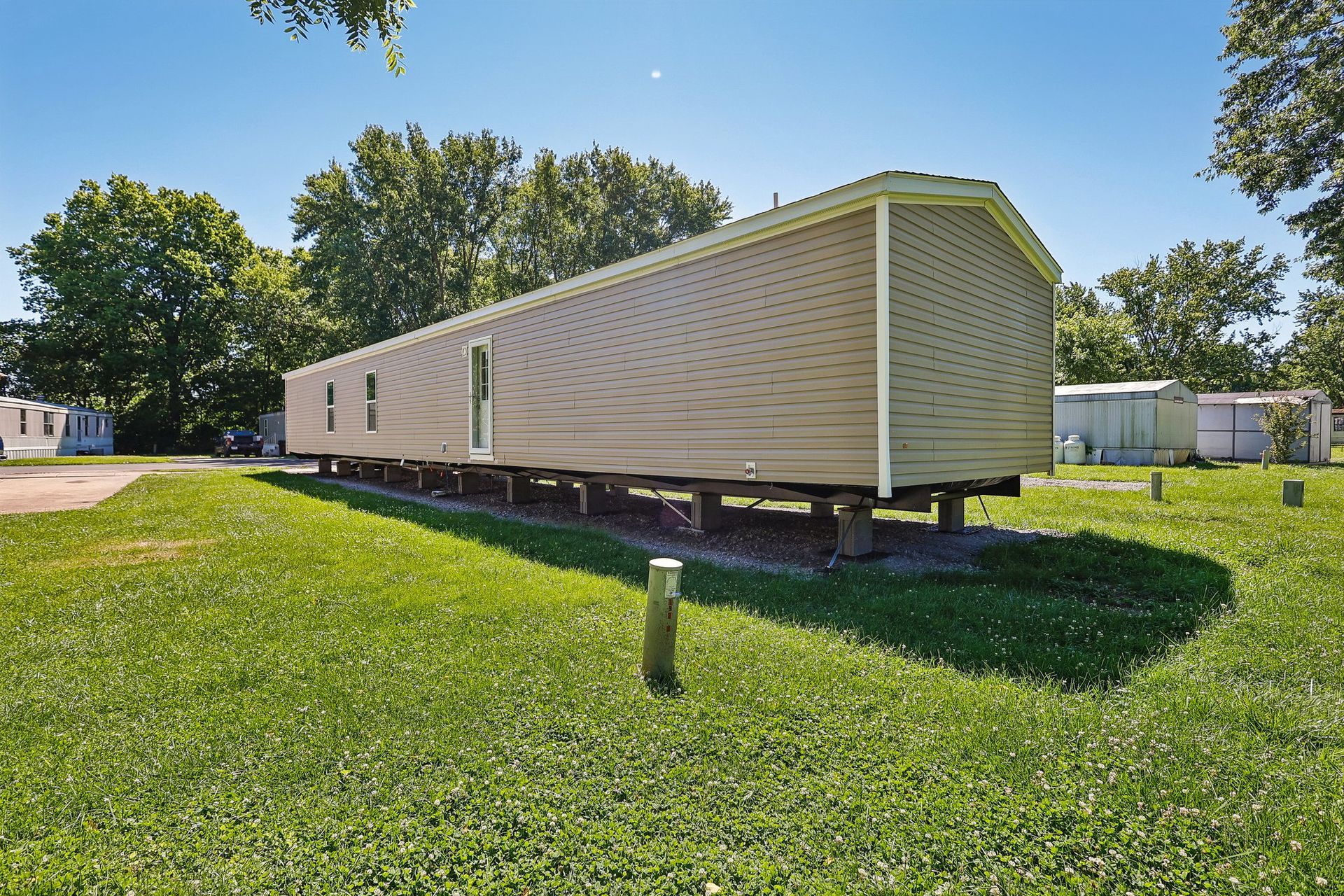 Rear side view of modern manufactured home in a peaceful community.