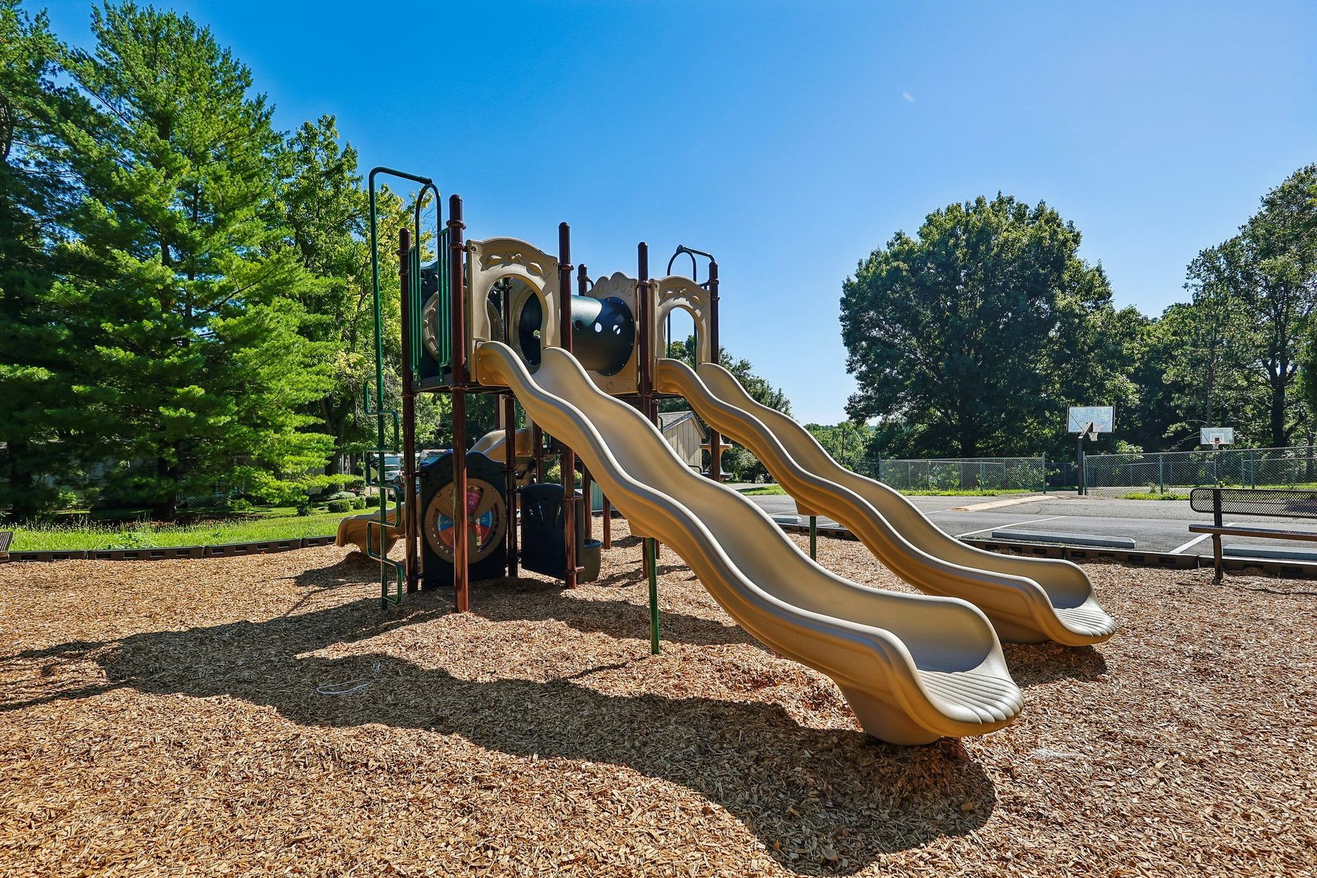 Playground with slides and play structure at Shadow Lake Village community.