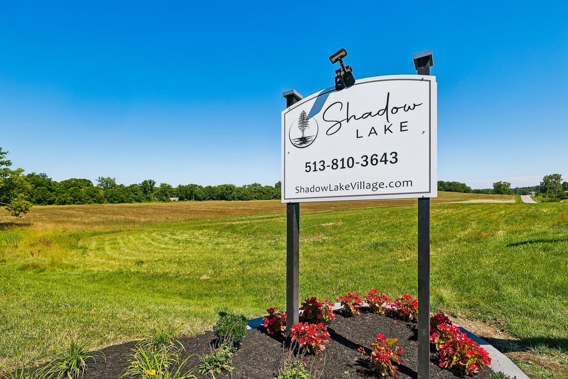 Entrance sign welcoming visitors to Shadow Lake Village manufactured home community.