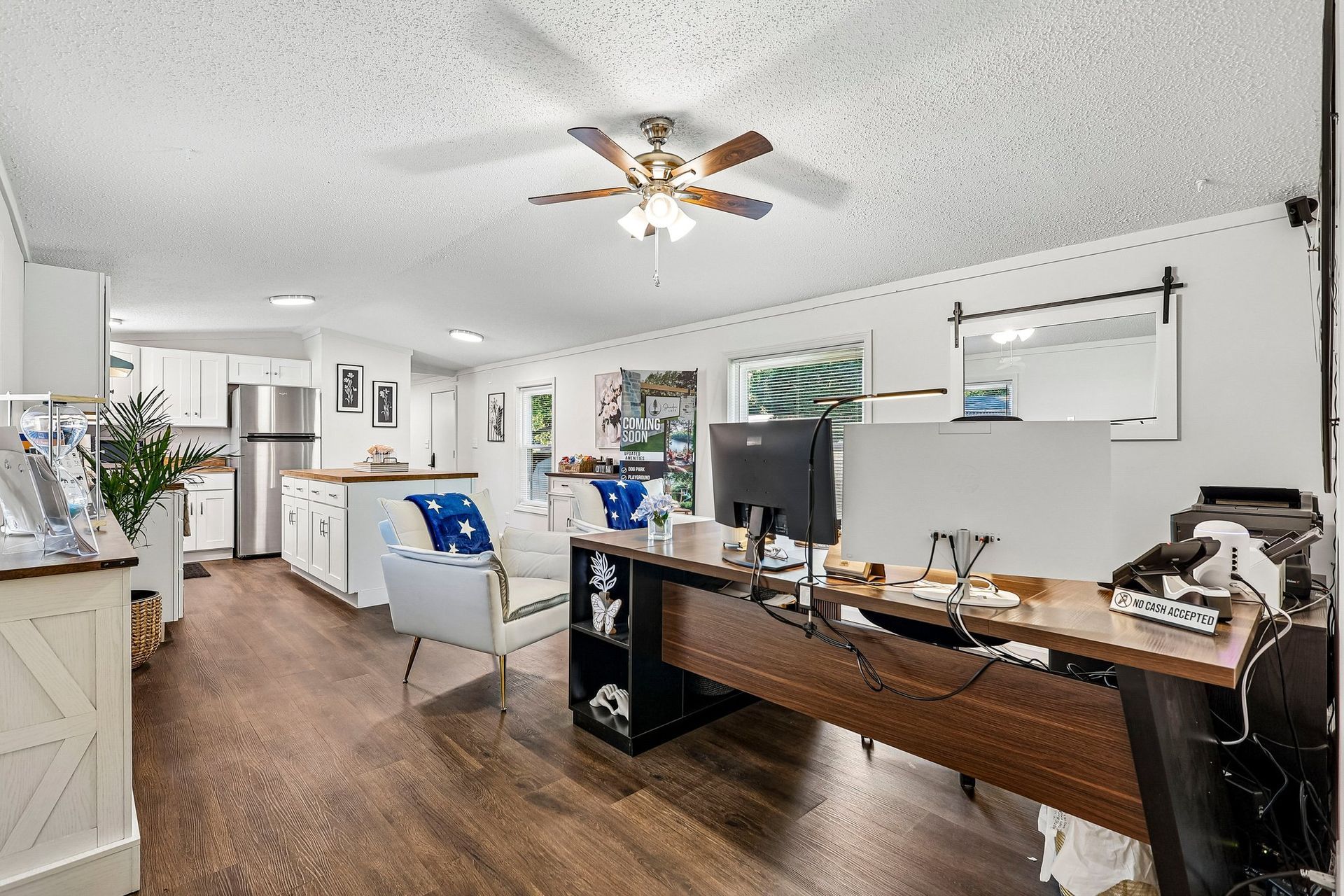 Open-concept living room and kitchen with modern finishes and natural light.