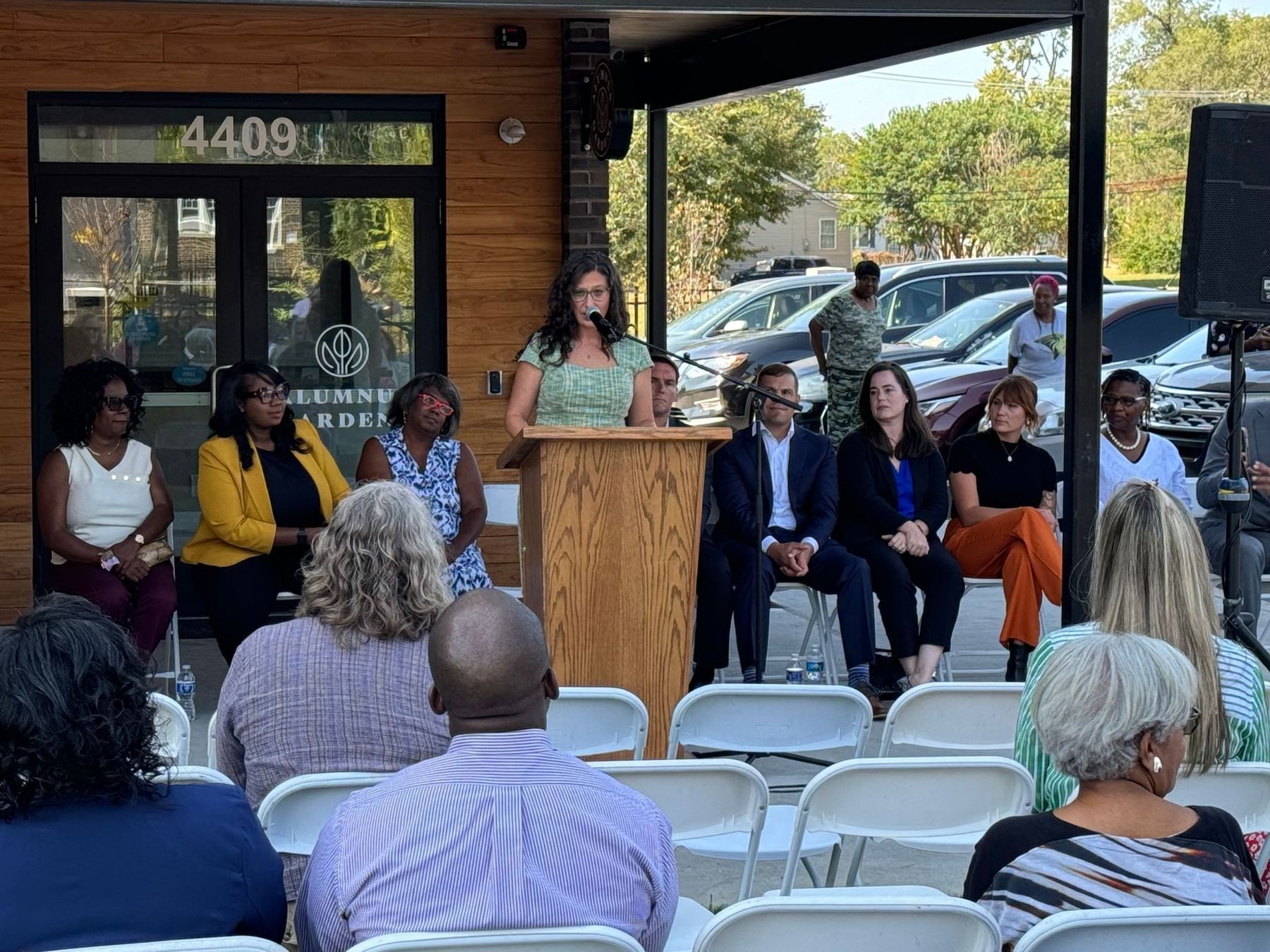 The audience at the Alumnus Gardens opening, with officials seated behind the podium.