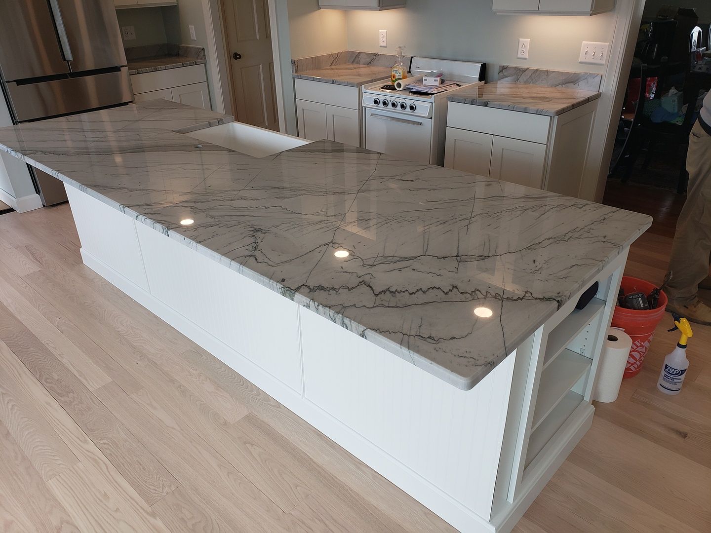A kitchen with a large island in the middle of it.