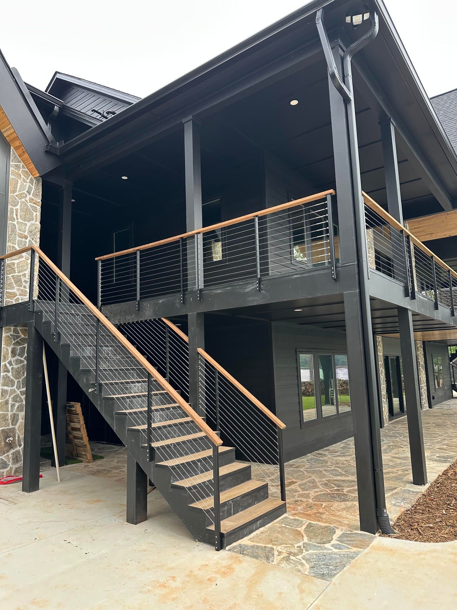 Exterior cable railing deck and staircase on a modern black home in Greenville, SC