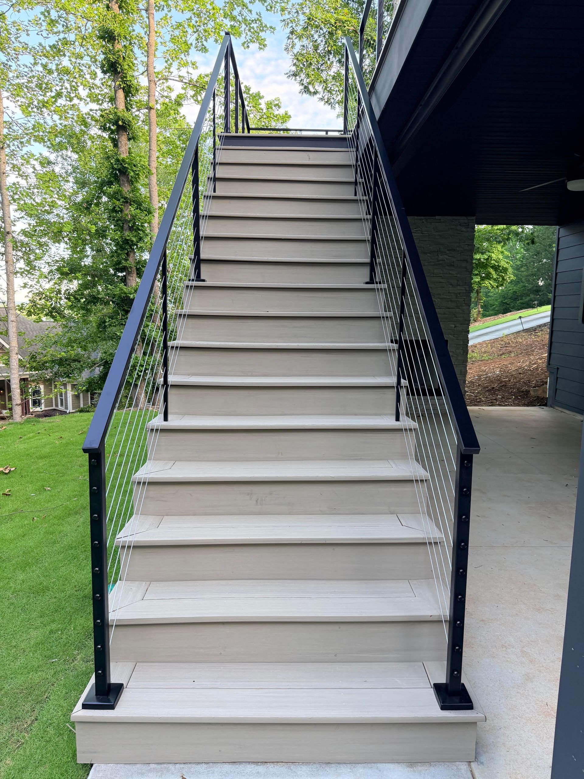 Exterior cable railing staircase beside an elevated deck, Greenville SC