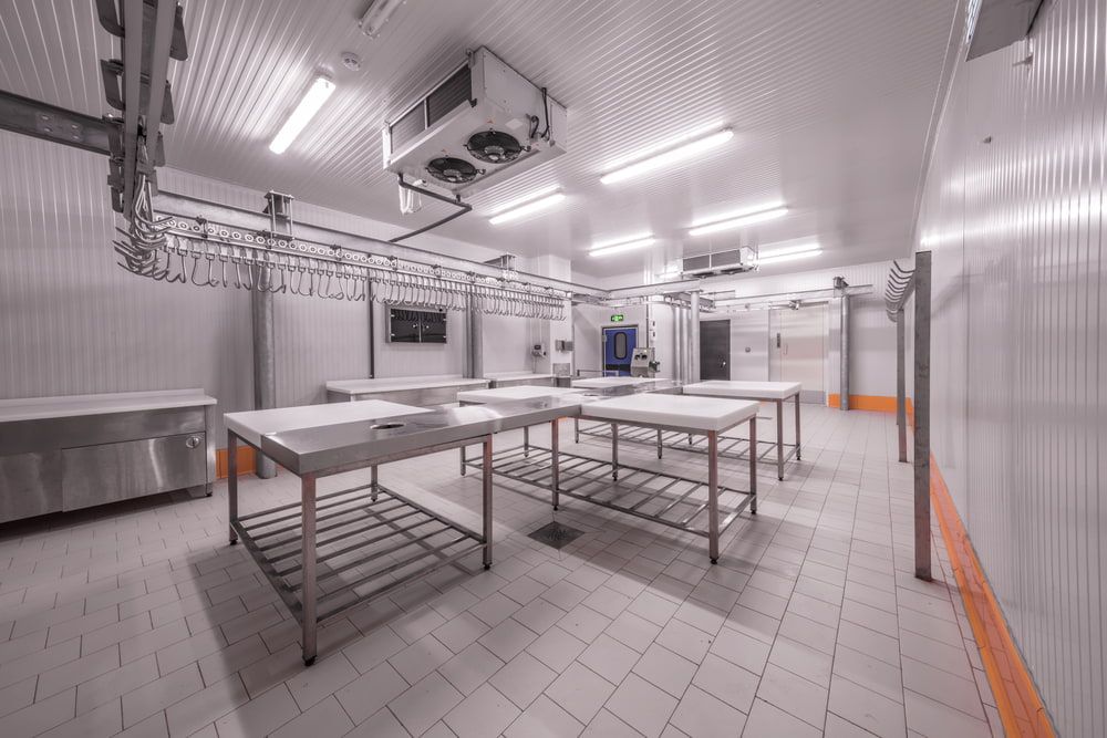 Empty Industrial Kitchen With Stainless Steel Tables — Noosa Refrigeration & Air-conditioning in Gympie, QLD
