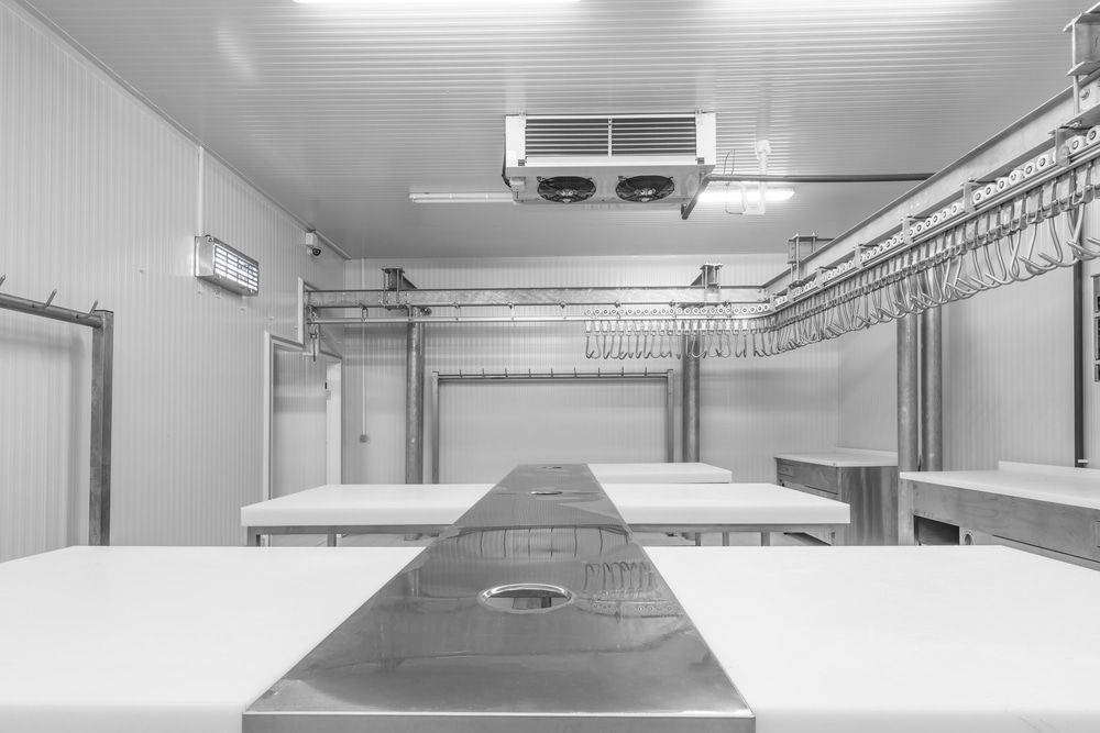 A Black and White Photo of a Kitchen With Tables and a Ceiling Fan — Noosa Refrigeration & Air-conditioning in Cooroy, QLD