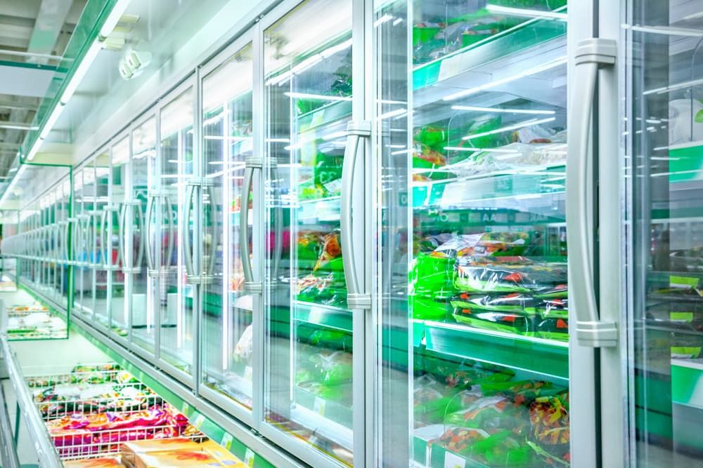 A Grocery Store Aisle With Large Glass-door Fridge — Noosa Refrigeration & Air-conditioning in Noosa, QLD