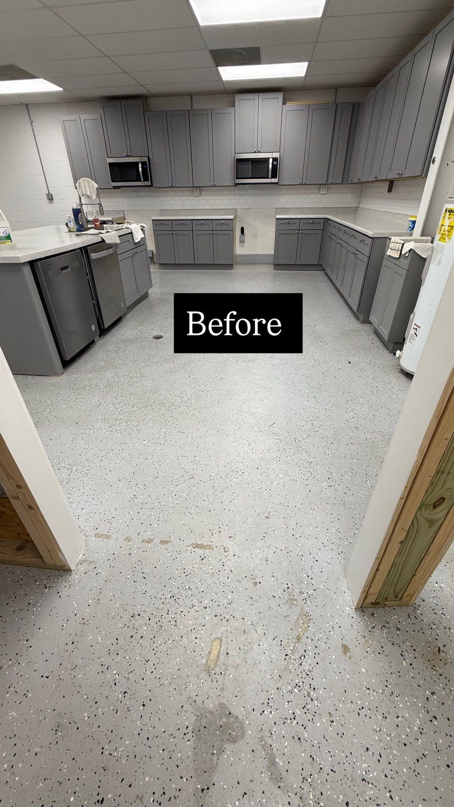 Empty gray break room with cabinets, speckled floor, and microwave; “Before” label near center.