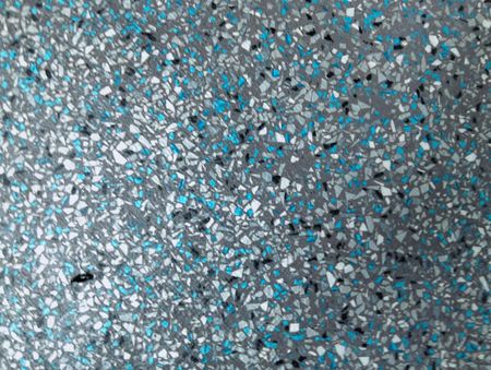 Abstract speckled gray and blue textured surface with scattered dark flecks