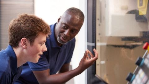 Black man talking to a boy