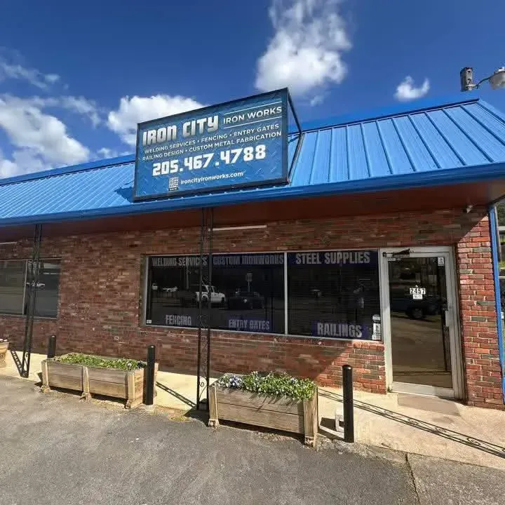 Brick storefront with blue roof and Iron 4th sign, steel supplies and railing shop.
