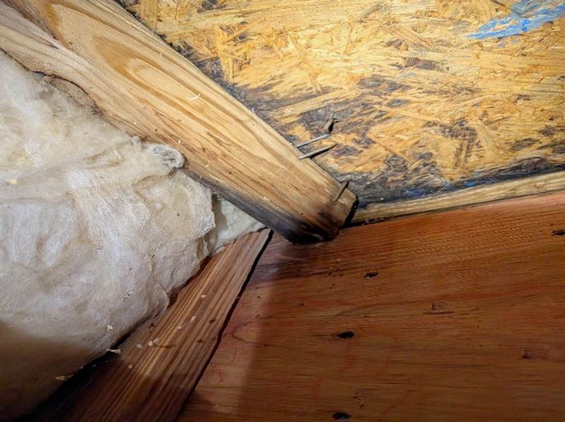 Evidence of water damage is observed at the interior and behind drywall in some areas.