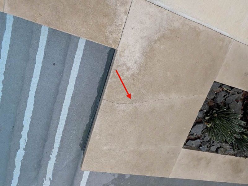 A crack can be tracked into the pool, and extends to the courtyard wall.