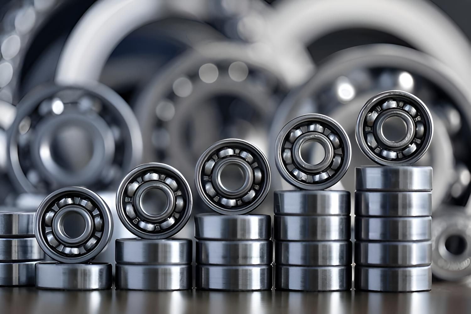 Ball bearings, close-up, stacked on gray metal bases, with more bearings in the blurred background. — Mid Coast Bearing Centre in Gloucester, NSW