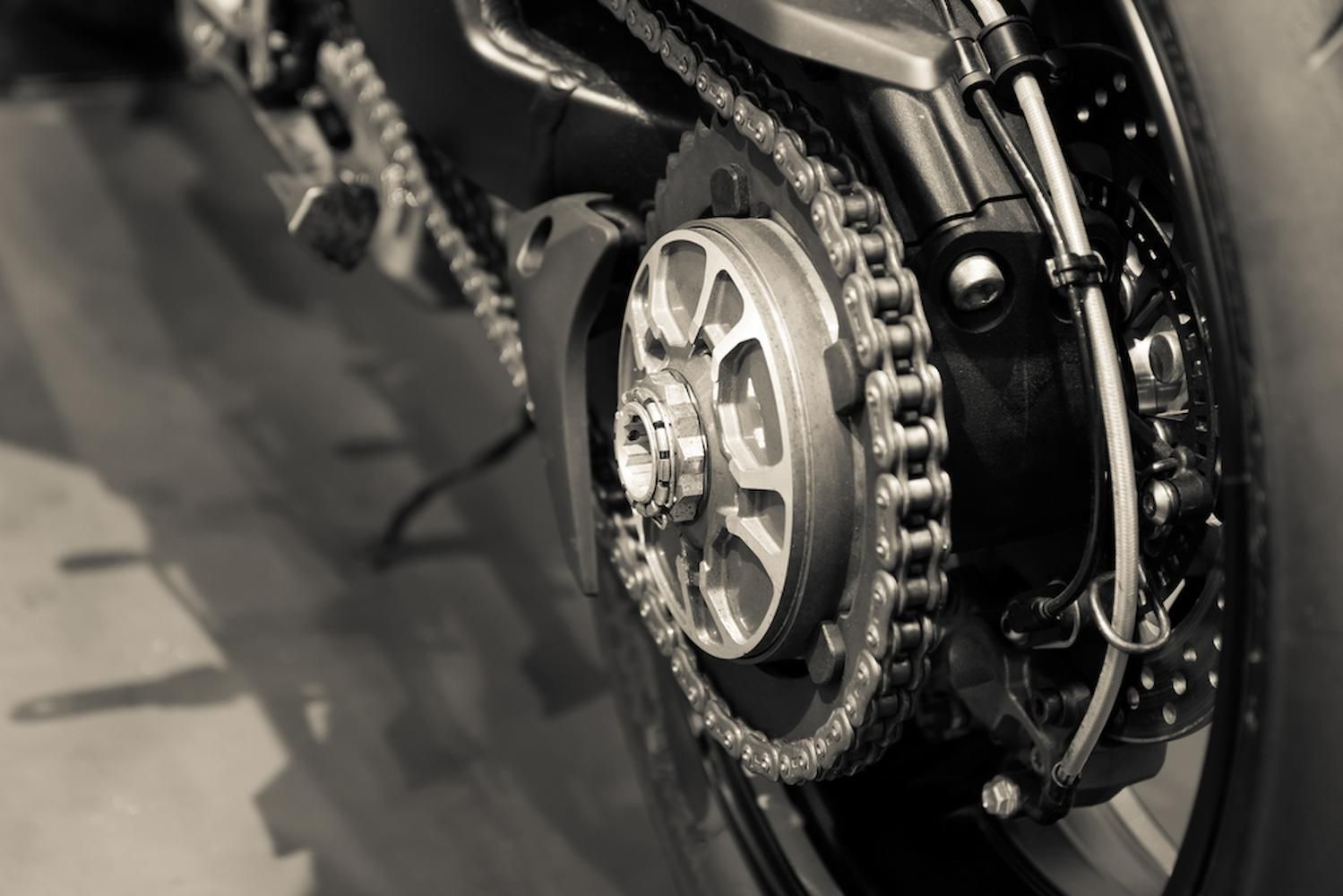 A Close Up of the Rear Wheel of a Motorcycle with Chains — Mid Coast Bearing Centre in Wauchope, NSW